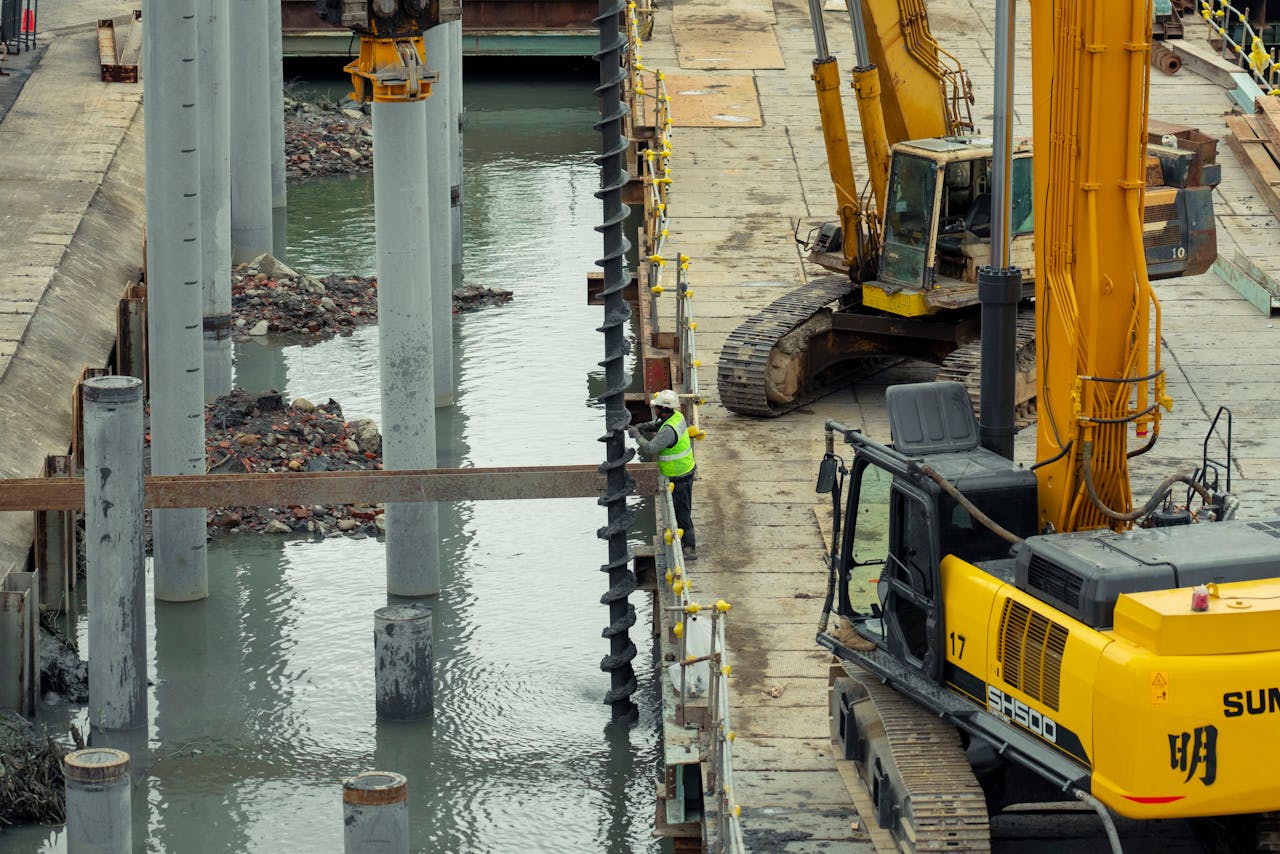 Home A construction site in Taipei, Taiwan, featuring heavy machinery and a worker on site.