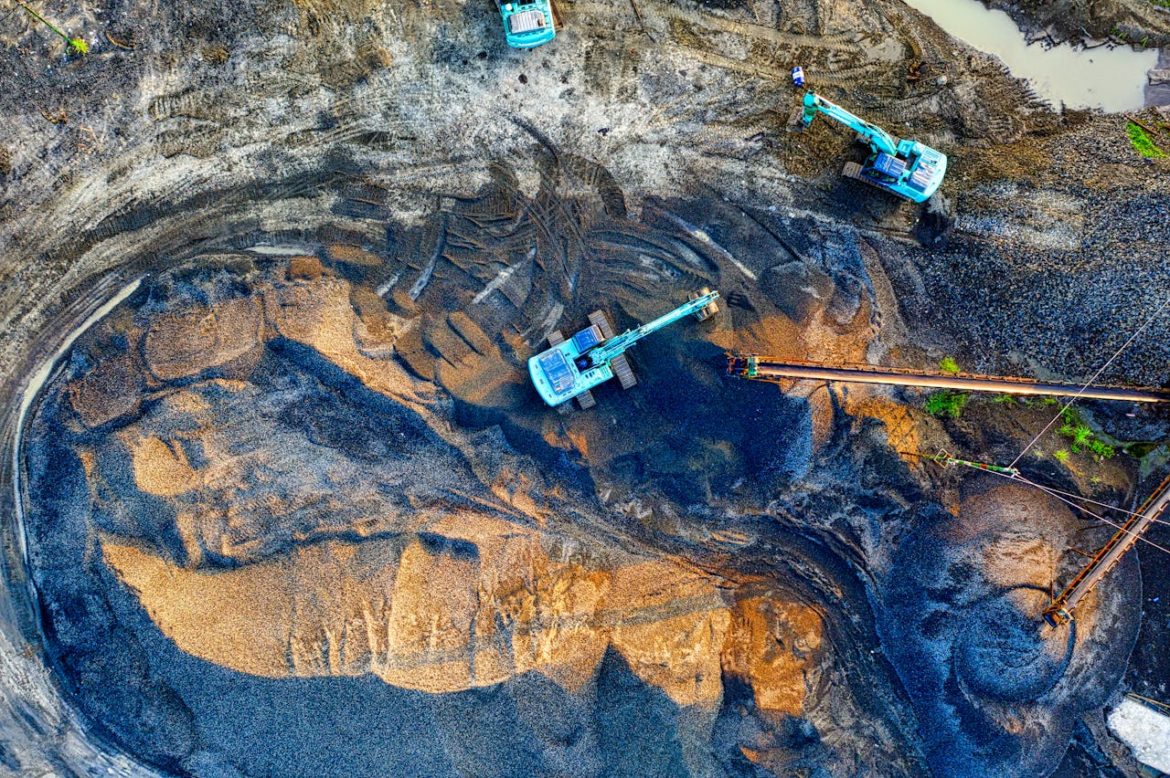 Aerial shot of an active mining site with machinery in Banten, Indonesia.